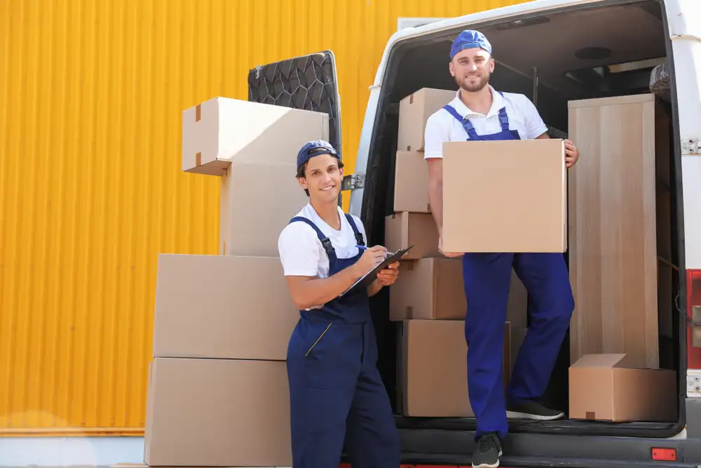 Professional movers carefully load furniture onto a moving truck